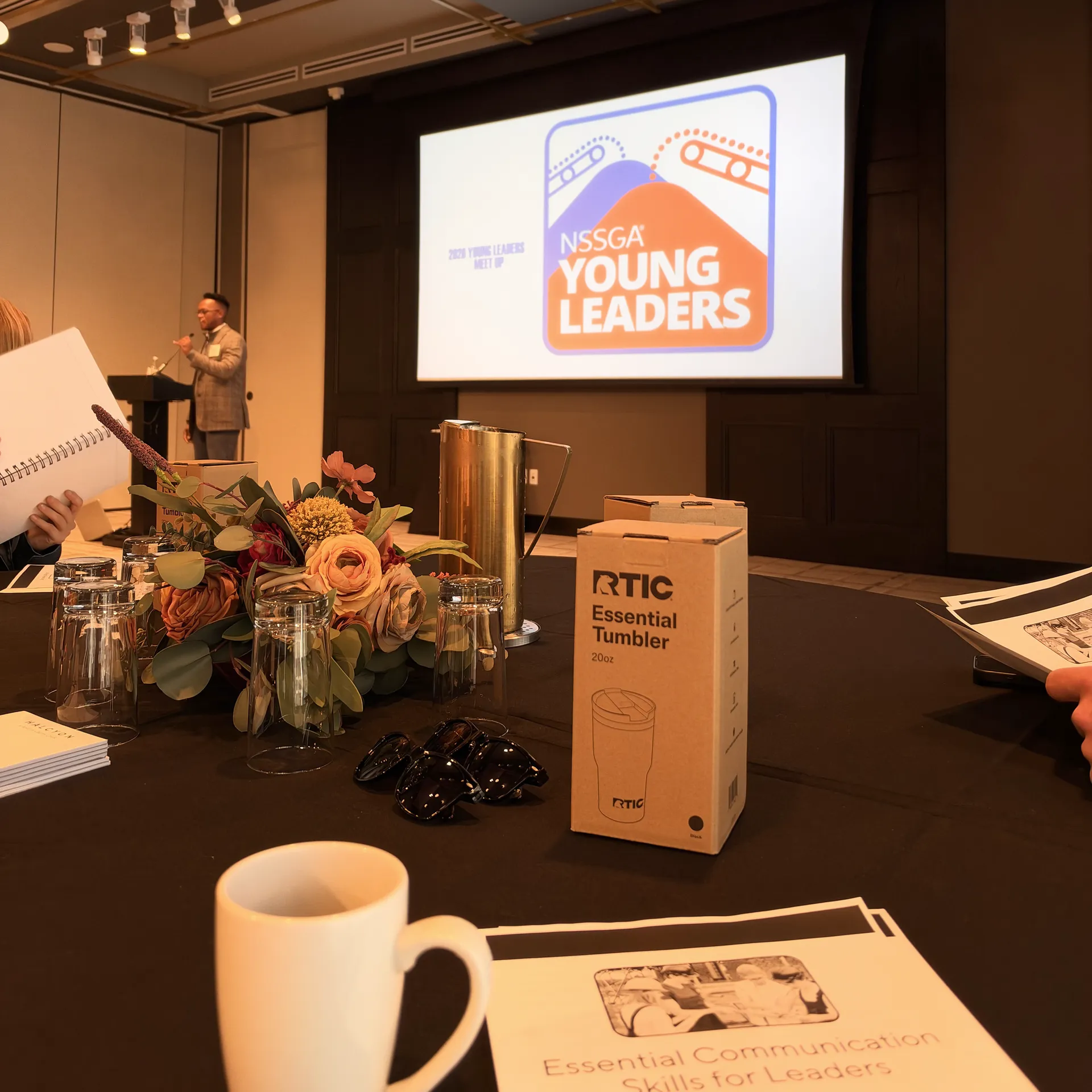 The Young Leaders meeting room in Denver, with the NSSGA Young Leaders slide on screen and the Essential Communication Skills for Leaders handout on the table